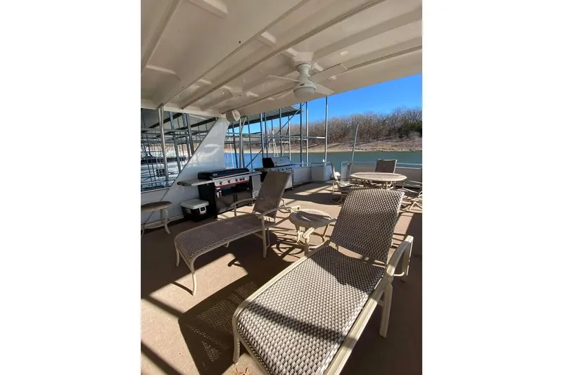 Slide: The Image of 2007 Summerset houseboat on serene lake, sunny day, metal canopy, scenic view. - 157