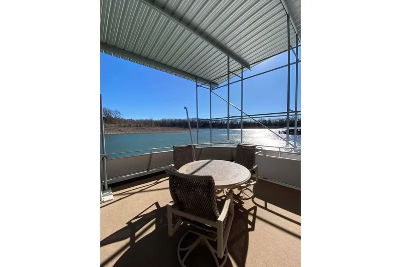 Slide: The Image of Outdoor deck of 2007 Summerset houseboat with seating, grill, and scenic water view. - 159