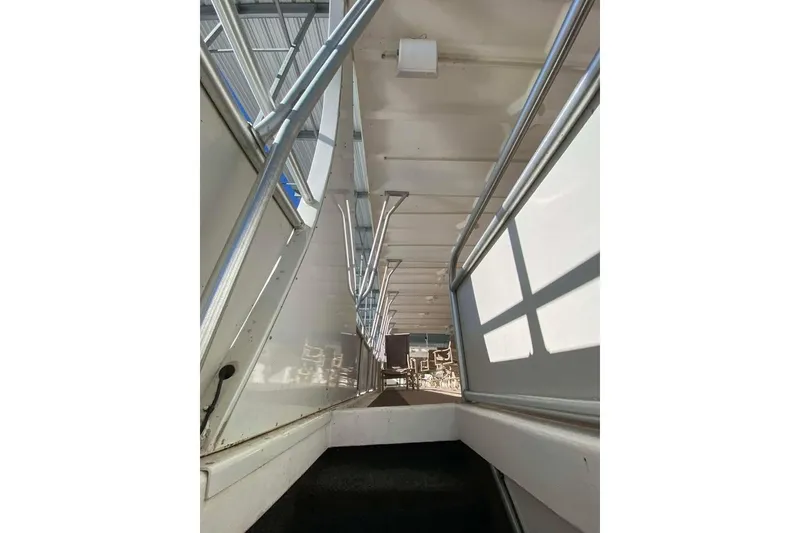 Slide: The Image of Outdoor deck of 2007 Summerset houseboat with lounge chairs and grill, overlooking water. - 160