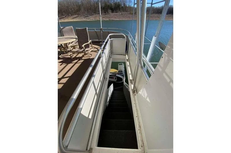 Slide: The Image of Covered deck of 2007 Summerset houseboat overlooking serene lake and shoreline. - 161