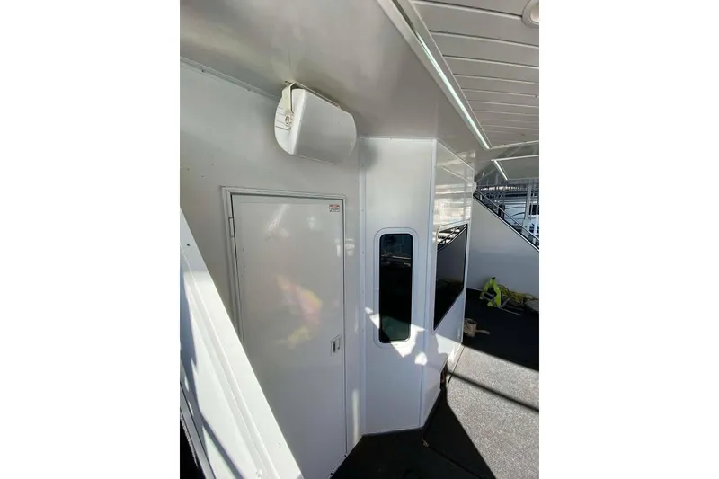 Slide: The Image of Staircase on 2007 Summerset houseboat, leading to lower deck with outdoor seating. - 164