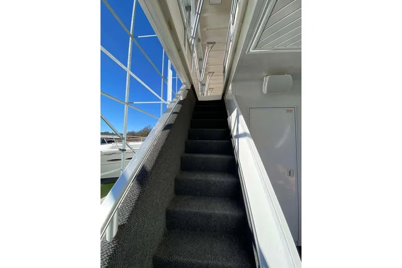 Slide: The Image of Staircase on 2007 Summerset 21' x 106' houseboat with logo, docked by water. - 165