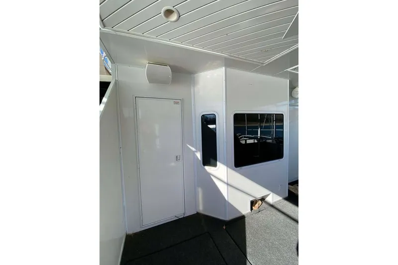 Slide: The Image of Side view of 2007 Summerset houseboat with slide, docked on a sunny day. - 166