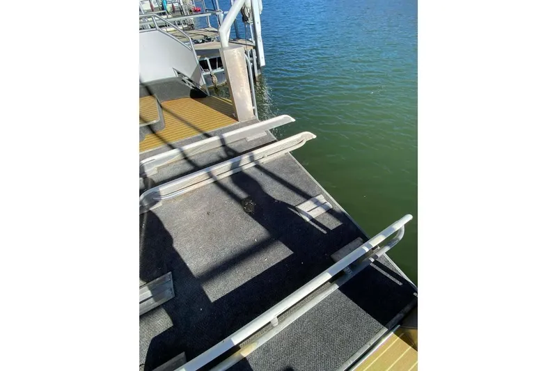 Slide: The Image of Interior view of a 2007 Summerset 21' x 106' houseboat with white walls and a window. - 167