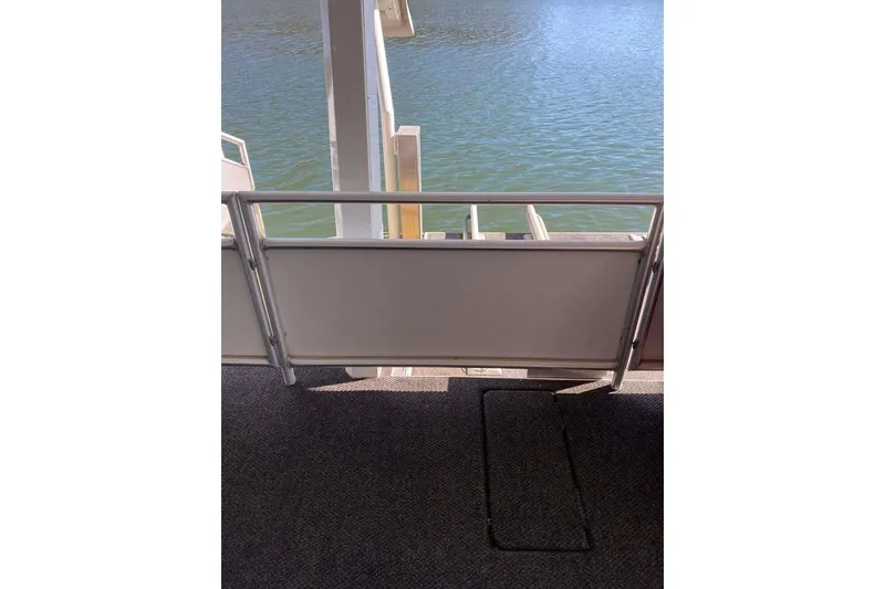 Slide: The Image of Interior view of a 2007 Summerset houseboat, featuring a white door and window. - 169