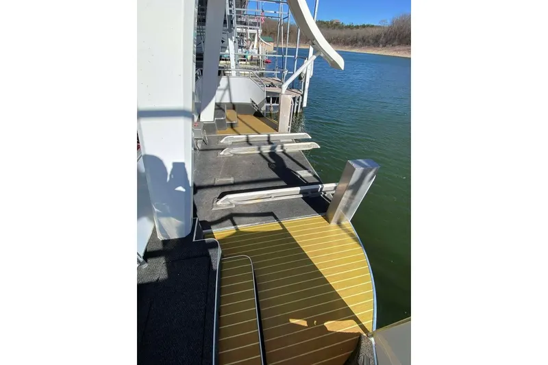 Slide: The Image of Summerset 21' x 106' houseboat, 2007 model, docked on a serene lake. - 174