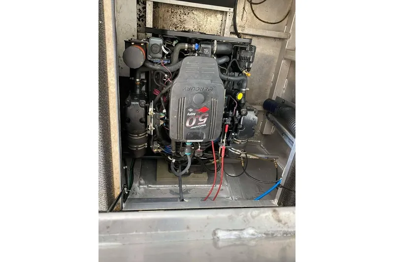 Slide: The Image of Summerset 21' x 106' 2007 houseboat docked on a serene lake with clear blue skies. - 180