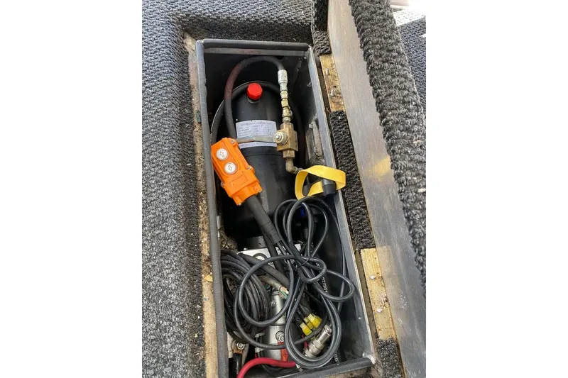 Slide: The Image of 2007 Summerset houseboat on a serene lake, featuring a spacious deck and clear blue skies. - 181