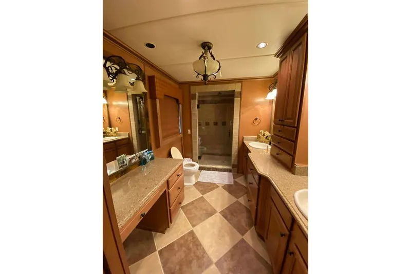 Slide: The Image of Wooden nightstand with granite top beside a bed, featuring a lamp. Summerset 21' x 106', 2007. - 190