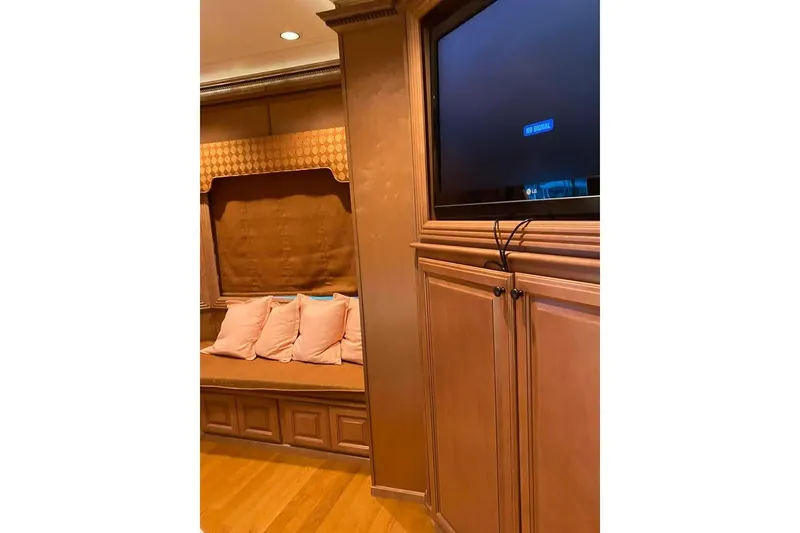 Slide: The Image of Luxurious bedroom interior in 2007 Summerset houseboat, featuring wood paneling and cozy seating. - 192