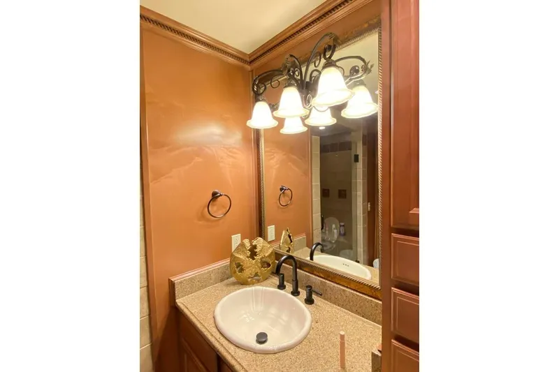 Slide: The Image of Bathroom sink with granite countertop and wooden cabinets, Summerset 21' x 106', 2007 model. - 202