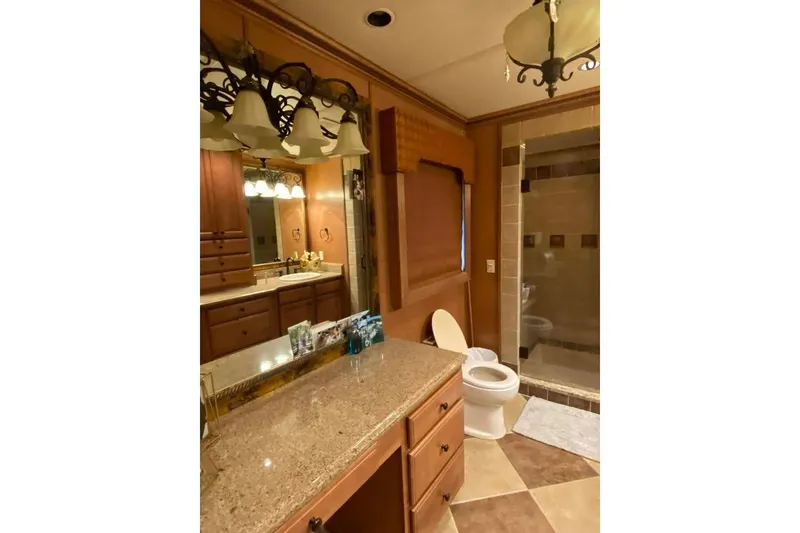 Slide: The Image of Luxurious bathroom in 2007 Summerset model, featuring elegant lighting and granite countertops. - 204