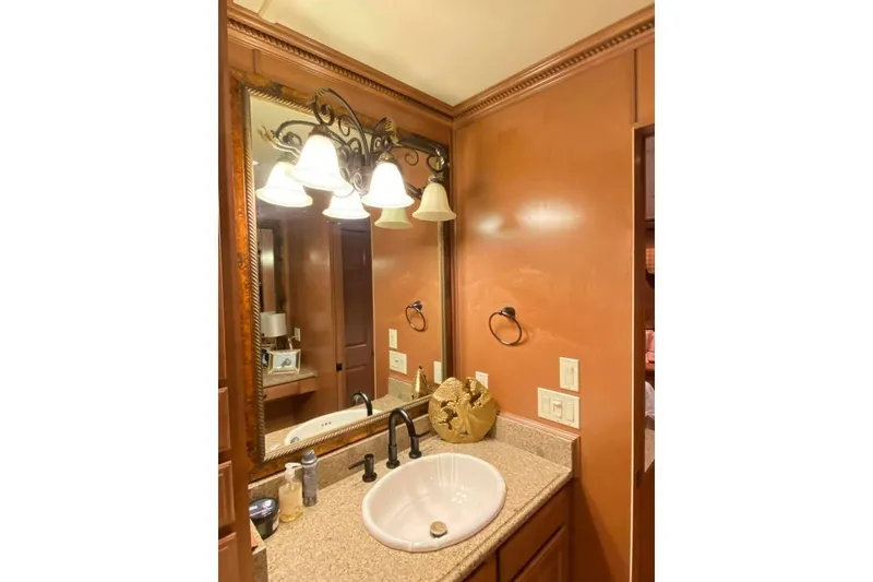 Slide: The Image of Luxurious bathroom vanity with ornate lighting in 2007 Summerset model. - 205