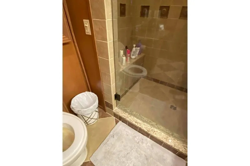 Slide: The Image of Luxurious bathroom in 2007 Summerset model, featuring toilet and glass shower enclosure. - 206