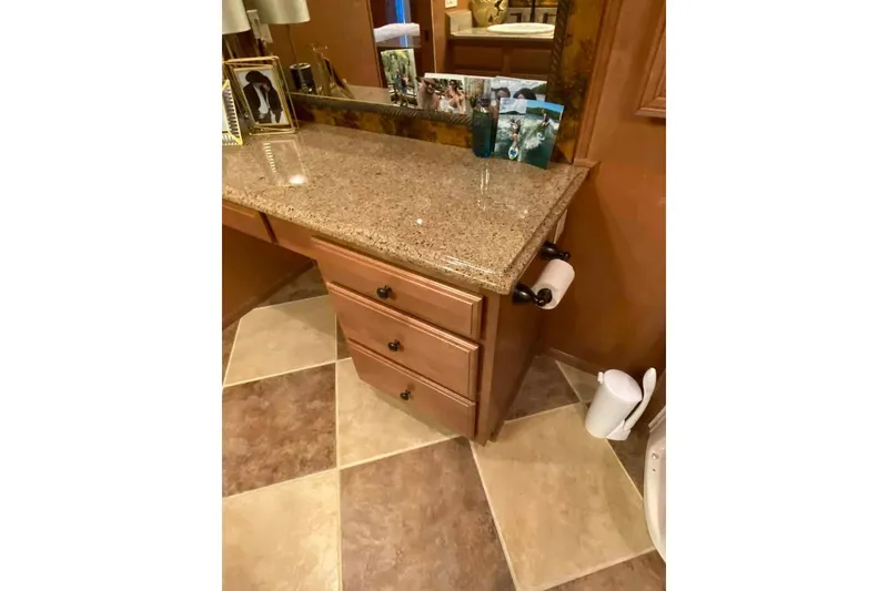 Slide: The Image of Luxurious bathroom vanity with ornate mirror and lighting in 2007 Summerset model. - 208