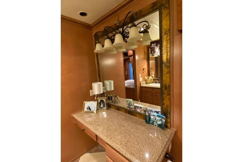 Slide: The Image of Luxurious bathroom in 2007 Summerset model, featuring wooden cabinetry and a glass shower. - 210