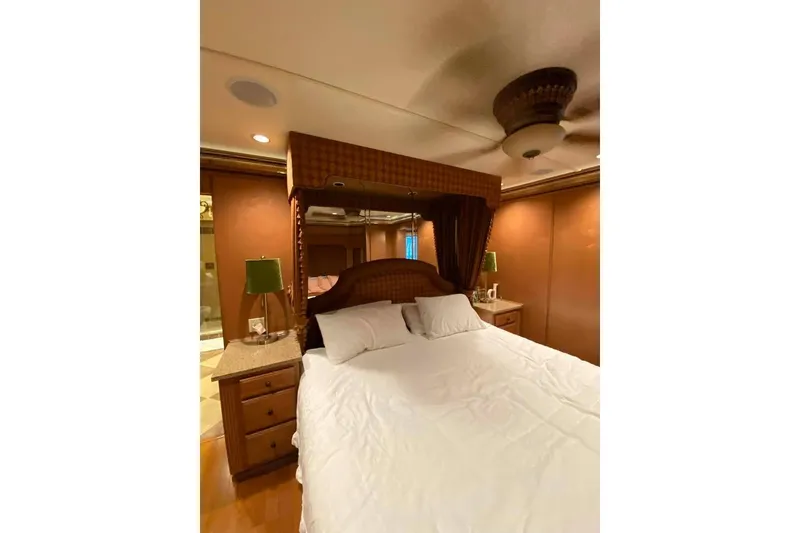 Slide: The Image of Bathroom vanity with granite countertop, wooden drawers, and decorative photos, in a 2007 Summerset model. - 211