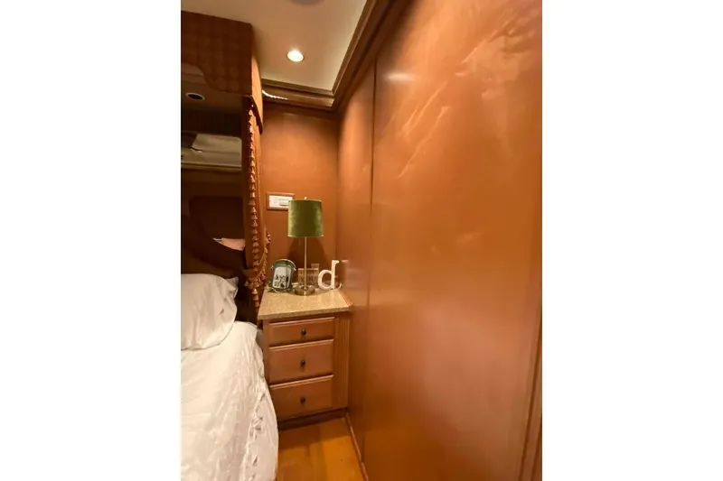 Slide: The Image of Luxurious bedroom in 2007 Summerset houseboat, featuring elegant wood paneling and cozy bedding. - 223