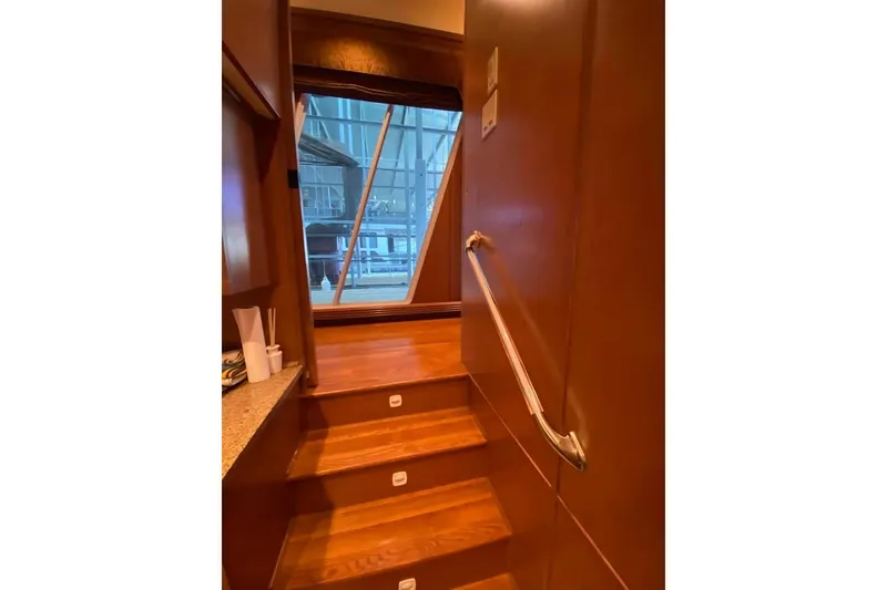 Slide: The Image of Narrow hallway with wooden flooring and wall sconce lighting on a 2007 Summerset houseboat. - 229