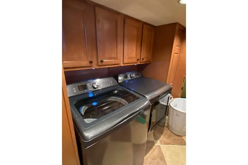 Slide: The Image of Interior stairs of 2007 Summerset 21' x 106' houseboat with wooden finish and handrail. - 232