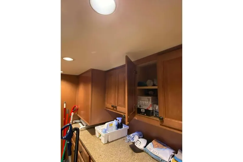 Slide: The Image of Interior of 2007 Summerset houseboat with wooden cabinets and stairs, featuring a large window. - 233