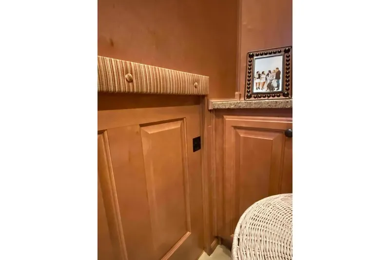 Slide: The Image of Laundry room with wooden cabinets and cleaning supplies, Summerset 21' x 106', 2007 model. - 236