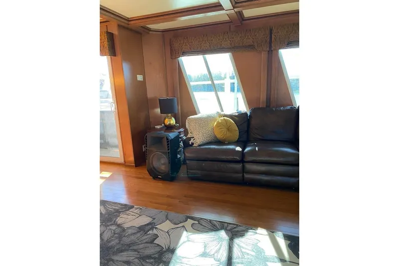 Slide: The Image of Interior view of a 2007 Summerset houseboat with elegant curtains and sliding glass door. - 24
