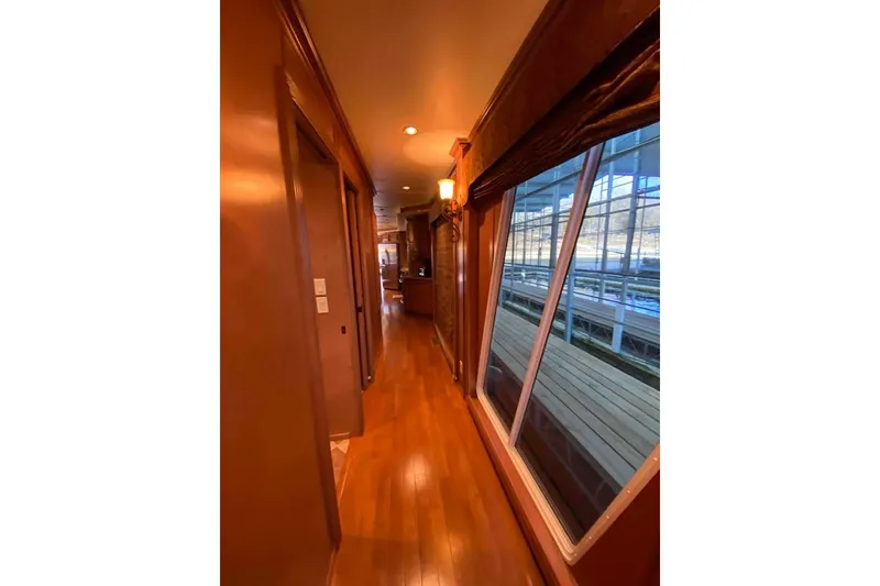 Slide: The Image of Wood-paneled hallway with wooden flooring in a 2007 Summerset 21' x 106' model. - 243