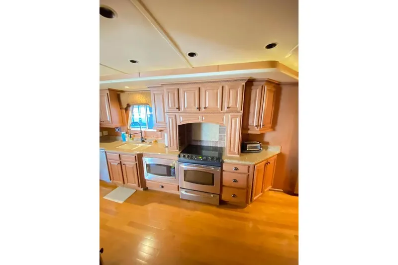 Slide: The Image of Interior view of 2007 Summerset houseboat with wooden cabinets and large windows. - 273