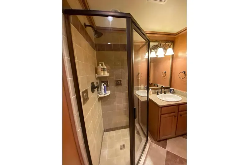 Slide: The Image of Wooden kitchen cabinets and textured wall in a Summerset 21' x 106', 2007 model. - 275