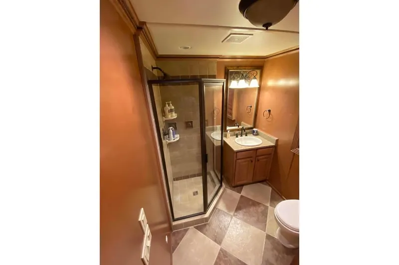 Slide: The Image of Luxurious bathroom with glass shower, dual sinks, and elegant lighting in a 2007 Summerset model. - 278