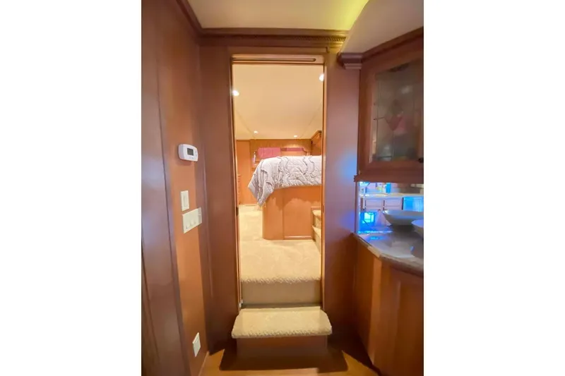 Slide: The Image of Cozy bedroom interior in 2007 Summerset 21' x 106' houseboat with wooden cabinetry. - 289