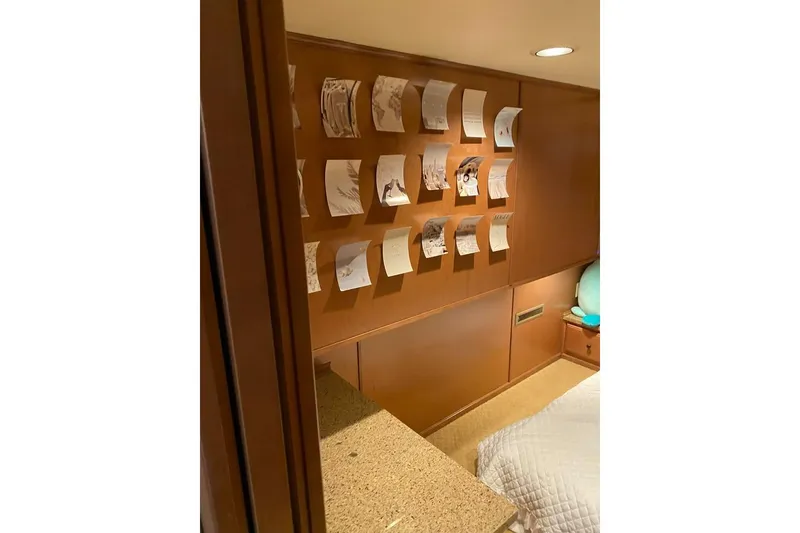 Slide: The Image of Modern kitchen with brown bar stools, wooden cabinets, and stainless steel appliances in a Summerset model. - 29