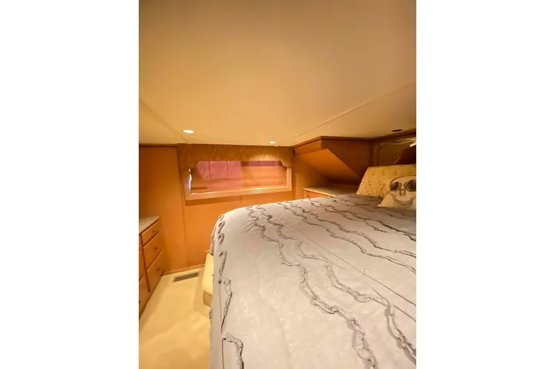 Slide: The Image of Cozy bedroom interior in 2007 Summerset 21' x 106' houseboat, featuring elegant bedding. - 290