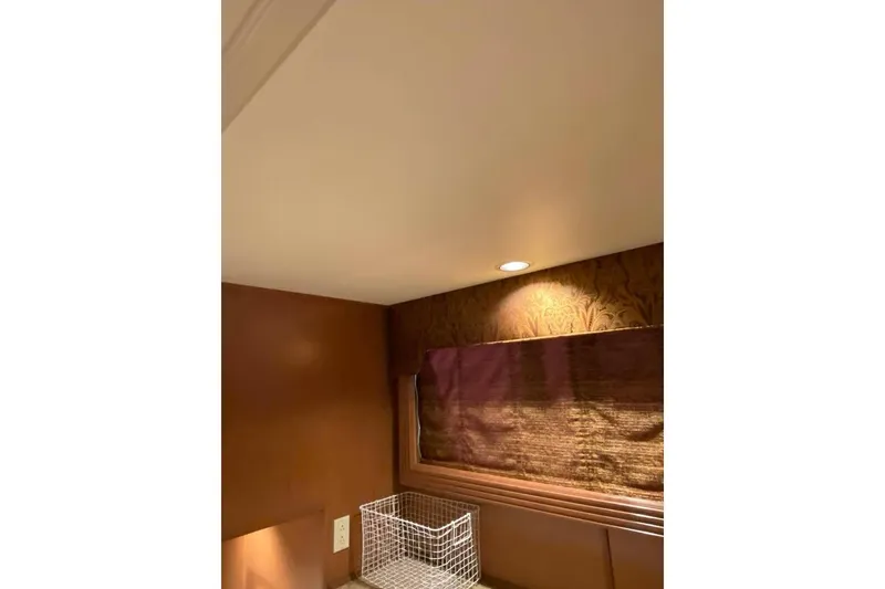 Slide: The Image of Interior of 2007 Summerset houseboat, featuring wood paneling and storage area. - 299