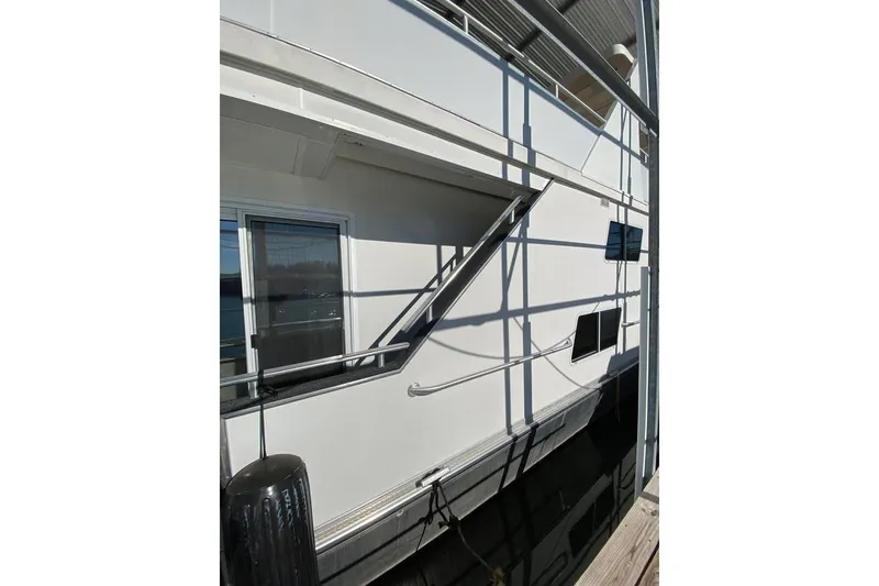 Slide: The Image of 2007 Summerset houseboat with outdoor seating, ceiling fans, and lake view. - 3