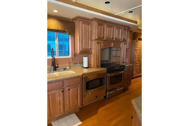 Slide: The Image of Cozy bedroom interior of 2007 Summerset 21' x 106' houseboat with wood paneling and soft lighting. - 30