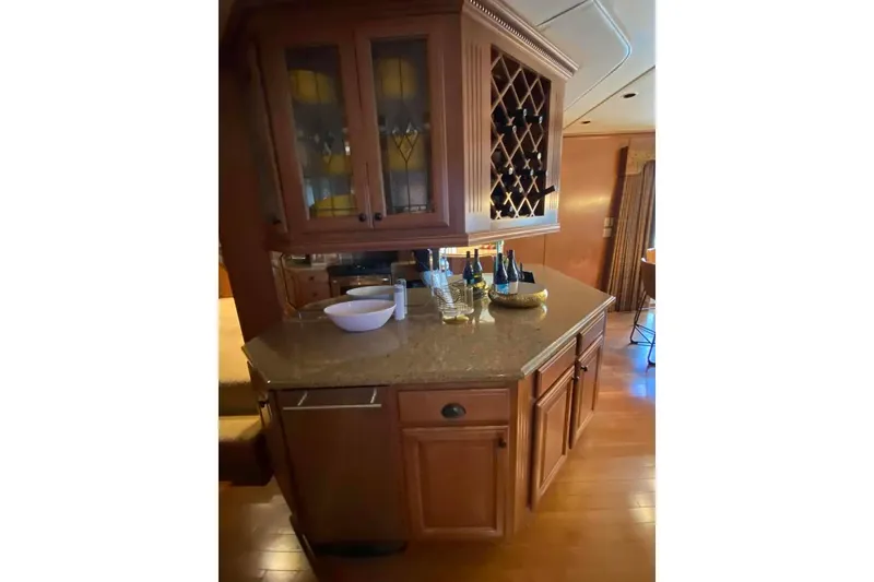 Slide: The Image of Kitchen interior of 2007 Summerset model, featuring wooden cabinets and granite countertop. - 311