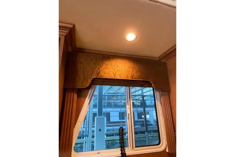 Slide: The Image of Interior view of a 2007 Summerset 21' x 106' houseboat with wooden cabinetry and ceiling lights. - 313
