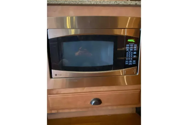 Slide: The Image of Luxurious kitchen area in 2007 Summerset houseboat with wooden cabinets and wine storage. - 314