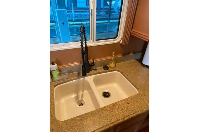 Slide: The Image of Interior view of a 2007 Summerset houseboat window with elegant drapery and lighting. - 316