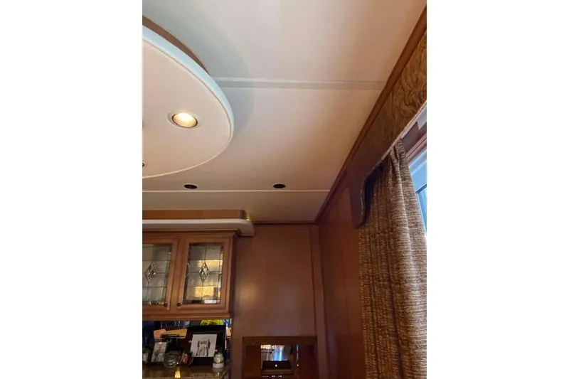 Slide: The Image of Elegant glass cabinet with wine glasses in a 2007 Summerset 21' x 106' model. - 321