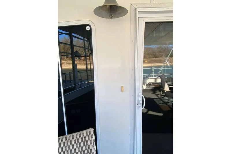 Slide: The Image of Outdoor seating area on a 2007 Summerset houseboat, overlooking a scenic lake view. - 366