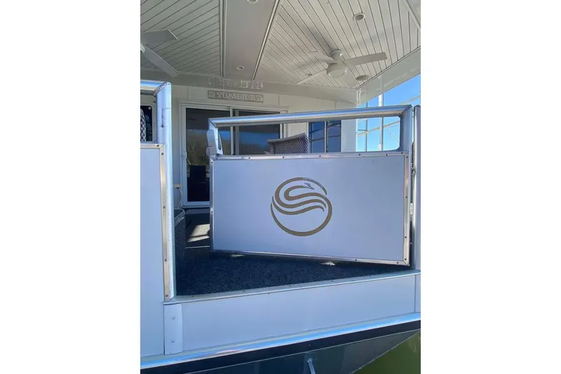 Slide: The Image of Sliding glass door on 2007 Summerset houseboat, overlooking serene water and deck area. - 371