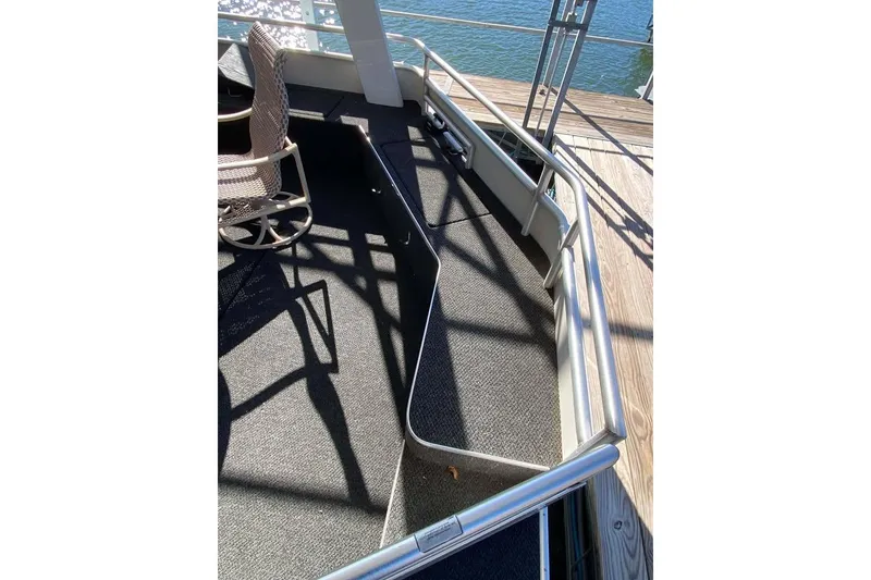 Slide: The Image of Deck area of a 2007 Summerset 21' x 106' houseboat with railing and chair. - 372