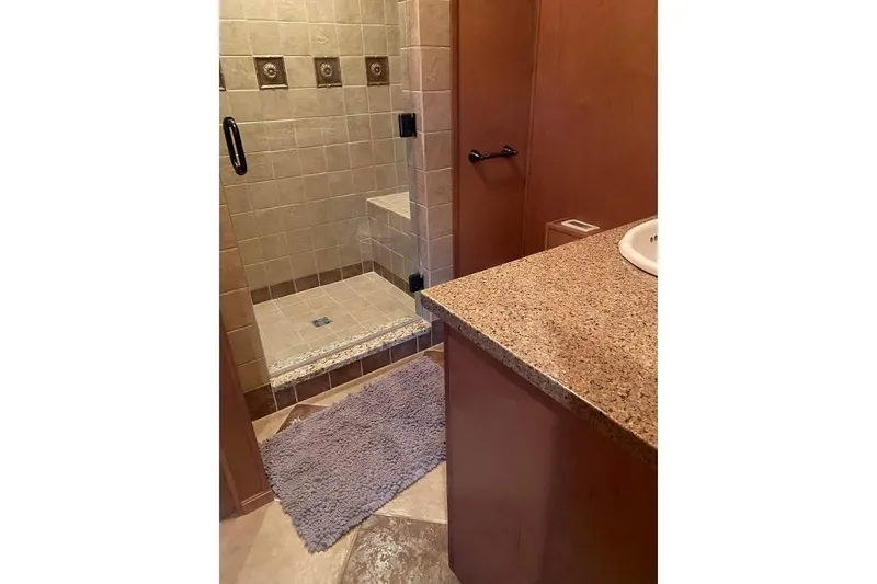 Slide: The Image of Interior of 2007 Summerset 21' x 106' houseboat bedroom with bed and wooden cabinetry. - 41