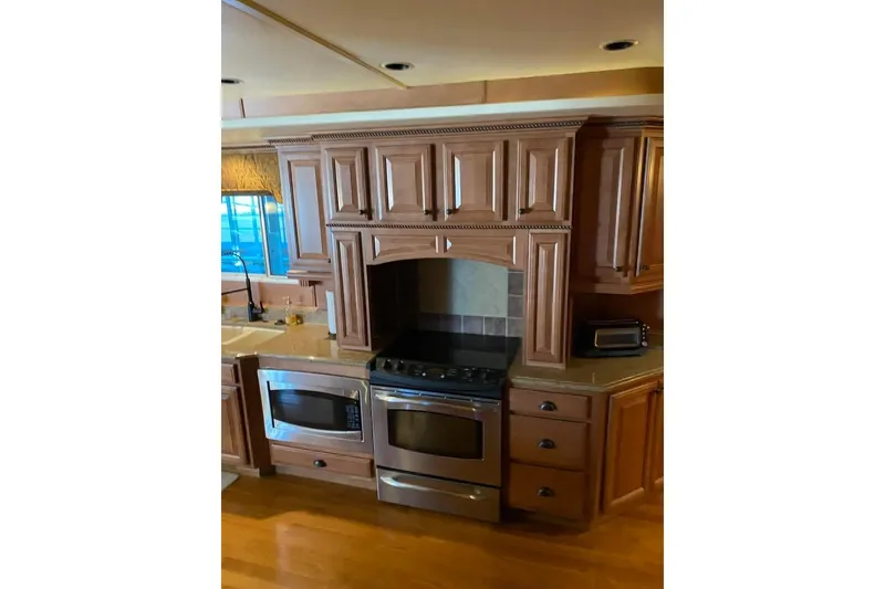 Slide: The Image of Elegant bathroom with wooden paneling, ornate mirror, and stylish lighting fixtures. Summerset 21' x 106', 2007. - 42