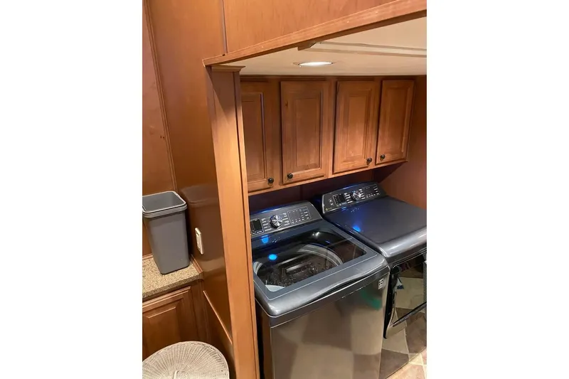 Slide: The Image of Interior hallway of 2007 Summerset houseboat, featuring wooden flooring and sliding glass door. - 53