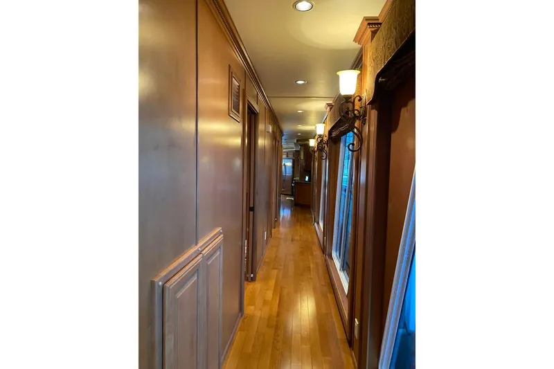 Slide: The Image of Laundry room with modern washer, dryer, wooden cabinets, and tiled floor in Summerset 2007 model. - 54