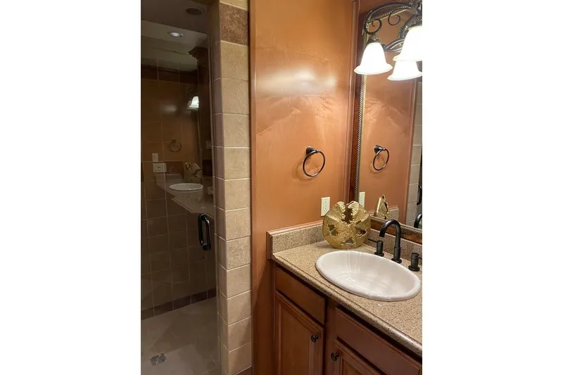 Slide: The Image of Luxurious bedroom interior in 2007 Summerset houseboat, featuring elegant wood paneling and cozy bedding. - 61